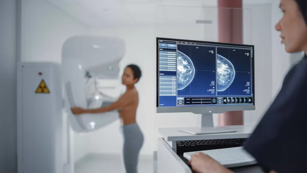 Woman doing Mammogram with Computer showing imaging