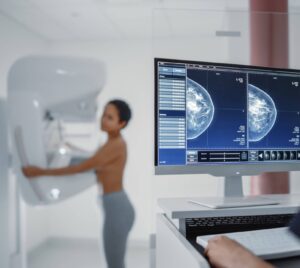 Woman doing Mammogram with Computer showing imaging